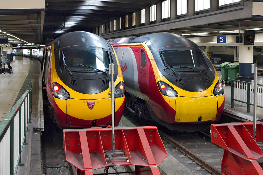 390156, VT 11.23 London Euston-Birmingham New Street (9G17, RT) & 350153, VT 11.40 London Euston-Manchester Piccadilly (1H66, 3L), London Euston station 
 Two class 390s wait to depart from London Euston. At platform 6, 390156 'Stockport 170' waits to form the 11.23 to Birmingham New Street. At platform 5, 390153 'Mission Accomplished' will work the 11.40 to Manchester Piccadilly. 
 Keywords: 390156 9G17 350153 1H66 London Euston station