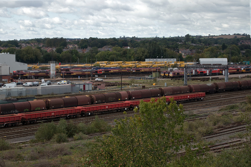 66199, 66012, 66247, 66211, 67019, 66182, 60065 & 60021, stabled & stored Toton yard 
 This is what the modern-day Toton is all about! A mass of locomotives mixed in with a variety of wagons and, at the rear, a lot of autoballasters. The locomotives on view are a mixture of those in current service and those stored. From left to right I can identify 66199, 66012, 66247, 66211, 67019 (stored since March 2015), 60065 'Spirit of Jaguar' and GBRf liveried 60021 'Pen-y-Ghent'. 
 Keywords: 66199 66012 66247 66211 67019, 66182, 60065 & 60021, stabled & stored Toton yard Spirit of Jaguar Pen-y-Ghent