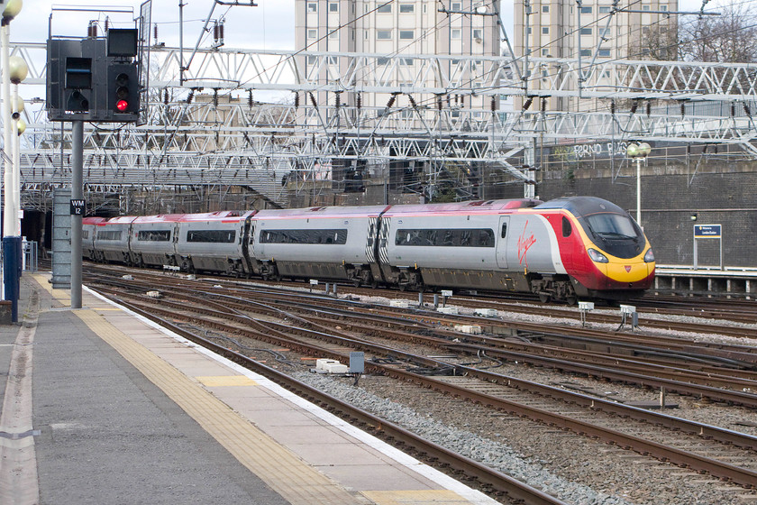 390118, VT 13.20 London Euston-Birmingham New Street (9G18), London Euston station 
 390118 glides into London Euston arriving with the 9G18 working from Birmingham New Street. Not that I fancy living in a tower block, but I have to say, one of the flats in view here at Euston would be of interest to me! 
 Keywords: 390118 13.20 London Euston-Birmingham New Street 9G18 London Euston station