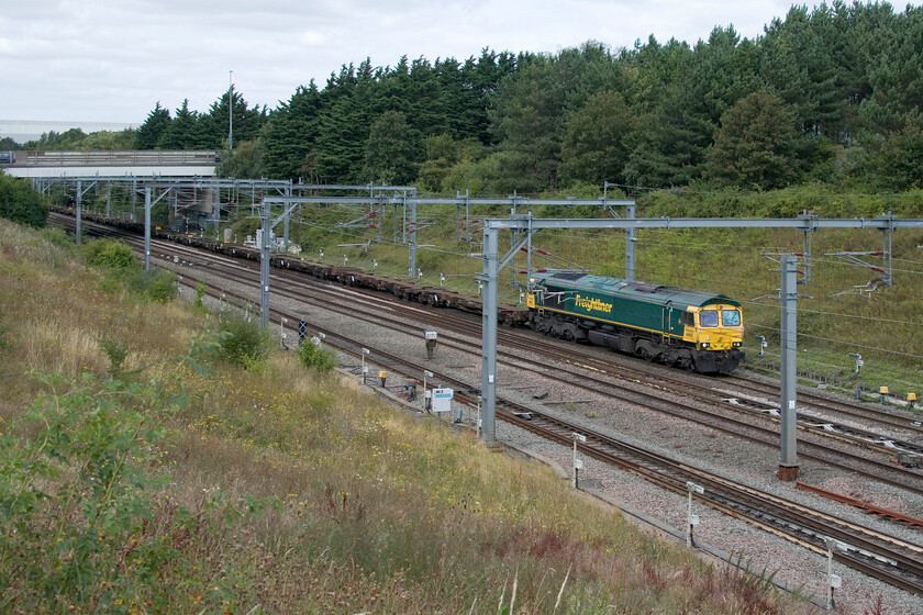 66953, 09.57 Crewe Basford Hall-Southampton MCT (Cancelled from Wembley) (4G11, 8L), Loughton Redway bridge, Milton Keynes 
 This is the first time that I recorded a photograph of 66953 actually working a train with the only other one that I have is of it in Crewe Basford Hall, see... https://www.ontheupfast.com/p/21936chg/26089866404/x86639-66953-stabled-crewe-basford It is seen at walking pace on the approach to Milton Keynes station, that is just to my right on the other side of the bridge on which I am standing, leading the diverted 4G11 09.57 Crewe Basford Hall to Southampton Freightliner. As can be seen, it is a train composed of fresh air with not a single box being conveyed, I don't know if this had anything to do with it being terminated at and cancelled from Wembley Yard. 
 Keywords: 66953 09.57 Crewe Basford Hall-Southampton MCT Cancelled from Wembley 4G11 Loughton Redway bridge Milton Keynes