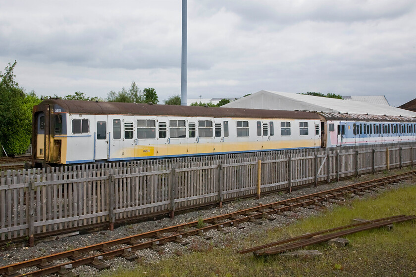 3545 & 4308, stored, NRM 
 At the back of the NRM former BR Class 414 4HAP car 61275 from set number 4308 that still wears its faded Network SouthEast livery. This unit spent most of its working life on the Kent Coast following construction at Eastleigh in 1959. In the foreground is the much newer, dating from 1973, 4VEP a single Class 423 carriage number 76875 from unit 3545 that wears the equally faded livery of one of the worst ever operators to grace our network, Connex South Eastern. This unit was withdrawn, along with all the other remaining slam-door stock, in October 2005. Interestingly, this unit has returned whence it came from being built here at York by BREL just a stone's throw from its location within the NRM complex.