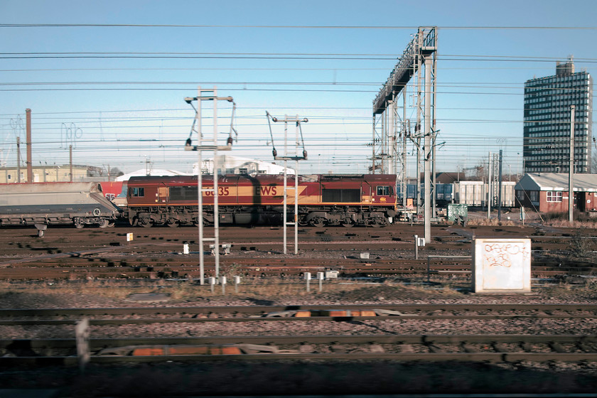 66135, stabled, Wembley Yard 
 66135 sits in the winter sun at Wembley Yard. It is attached to some hoppers but I failed to identify what the working was either as it left or arrived. 
 Keywords: 66135 stabled Wembley Yard