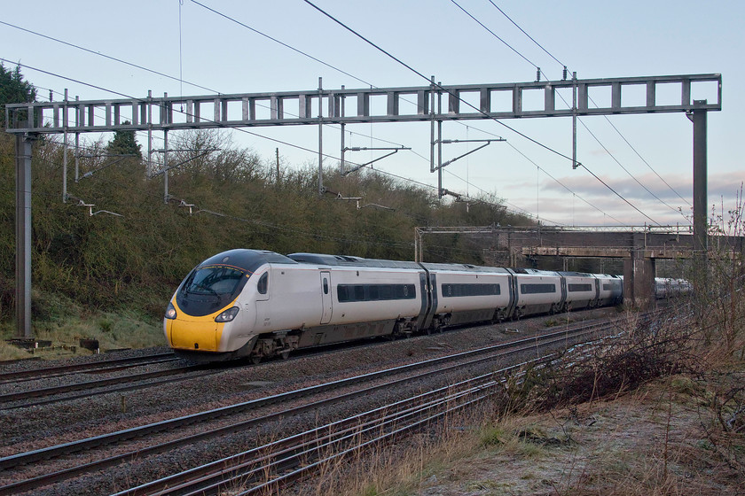 390103, VT 06.45 Wolverhampton-London Euston (1R12, RT), Ashton Road bridge 
 390106 'Rethink Mental Illness' passes Ashton Road bridge just south of Roade in Northamptonshire forming the 06.45 Wolverhampton to Euston. Taking photographs of up trains at this location was all but impossible up until the start of the year with contractors for Network Rail removing the entire lineside vegetation in preparation for embankment stabilisation work. 
 Keywords: 390103 06.45 Wolverhampton-London Euston 1R12 Ashton Road bridge Rethink Mental Illness Pendolino Avanti West Coast