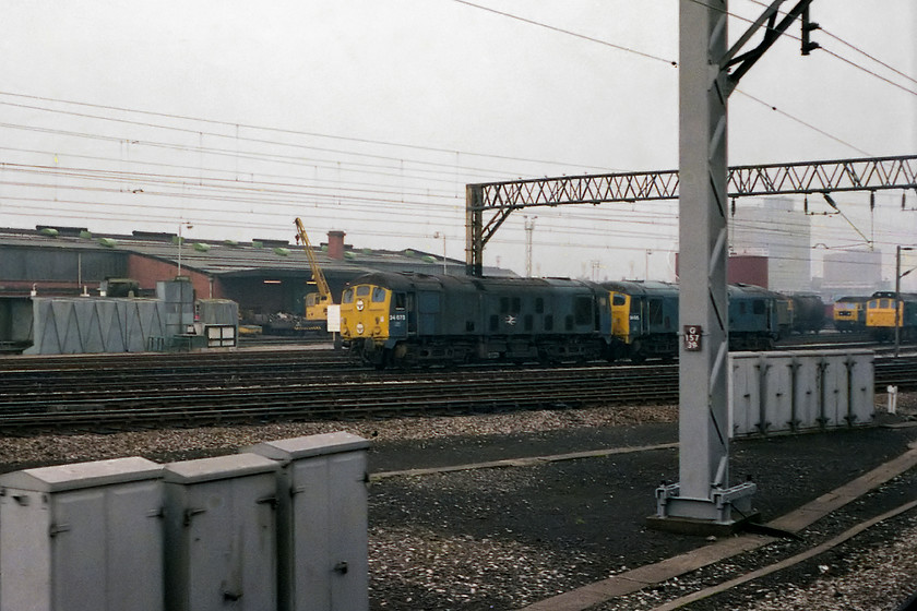 24073 & 24023 (condemned), class 47s & class 25, Crewe Yard 
 On the run in to Crewe station there was always a number of diesels in various states to the left of the train. In this image, two condemned type 2s, 24073 and 24023 await their fate. Beyond are a couple of class 47s and a 25. In my note book there are also another fifteen locomotives from first generation DMUs and 08s shunters to a class 85. 
 Keywords: 24073 24023 condemned class 47s class 25 Crewe Yard