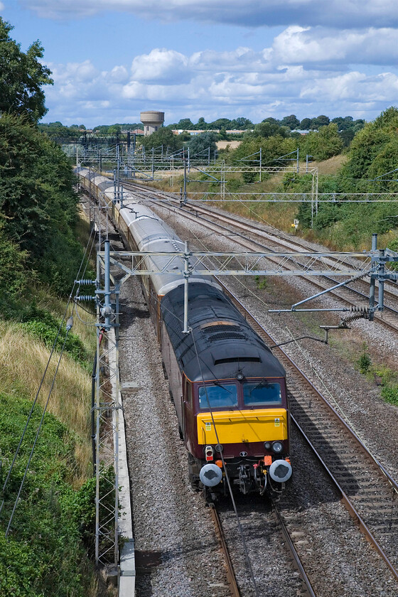 57601, Acton Lane-Carnforth ECS (5Z67), Victoria bridge 
 Looking good in some warm afternoon sunshine West Coast's 57601 brings up the rear of an Acton Lane to Carnforth empty stock move running as 5Z67. The train is seen taking the fast line on the approach to Roade thus avoiding Northampton and spoiling any photographers chances who had gathered to take a picture on the more normal and expected route. 
 Keywords: 57601 Acton Lane-Carnforth ECS 5Z67 Victoria bridge WCR West Coast Railways