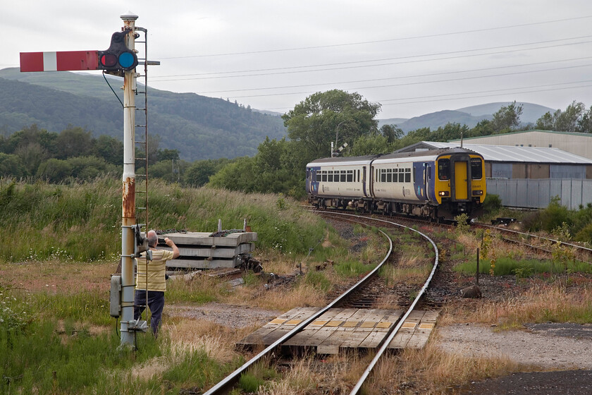 156481, NT 17.24 Sellafield-Barrow-in-Furness (2C38, 2E), Foxfield station 
 156481 approaches Foxfield station working the 17.24 Sellafield to Barrow-in-Furness service catering, largely, for the staff at the huge nuclear reprocessing plant. The train is about to pass the down starter/home signal controlled by the Furness signal box that is just out of shot to the right. Note Andy capturing the scene in the form of a video on his mobile 'phone. 
 Keywords: 156481 17.24 Sellafield-Barrow-in-Furness 2C38 Foxfield station