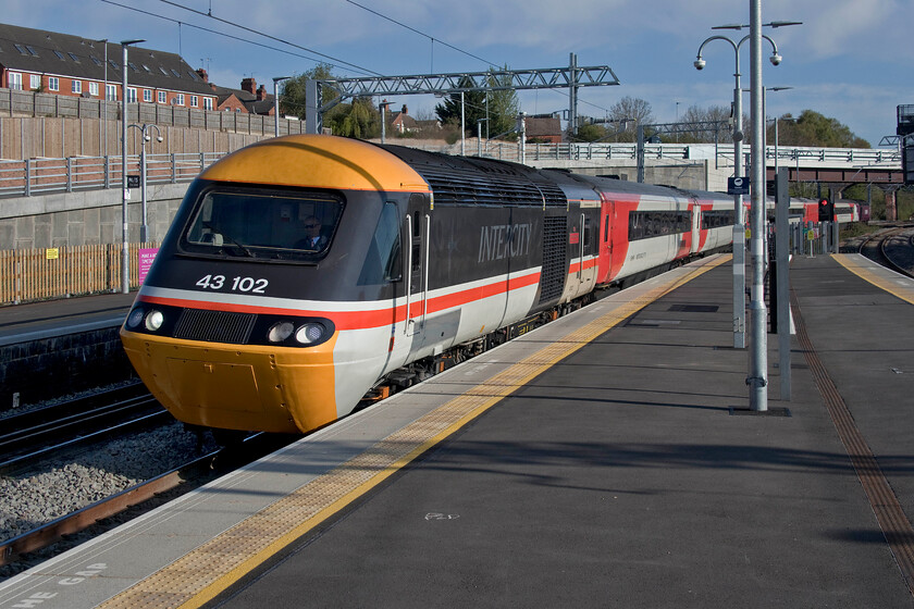 43102 (43302), EM 05.19 Leeds-London St. Pancras (1C15, 4E), Wellingbrough station 
 I had been attempting to get a photograph of celebrity HST power car 43102 'The Journey Shrinker' for some time since it was released on to the MML last February. I was ready for the arrival of the 1C15 05.19 Leeds to St. Pancras at Wellingborough station being the right side of the sun not knowing what would lead the train around the curve under the bridge. I was delighted when 43102 (formerly 43302) came into view! 
 Keywords: 43102 43302 05.19 Leeds-London St. Pancras 1C15 Wellingborough station East Midland Railway HST The Journey Shrinker