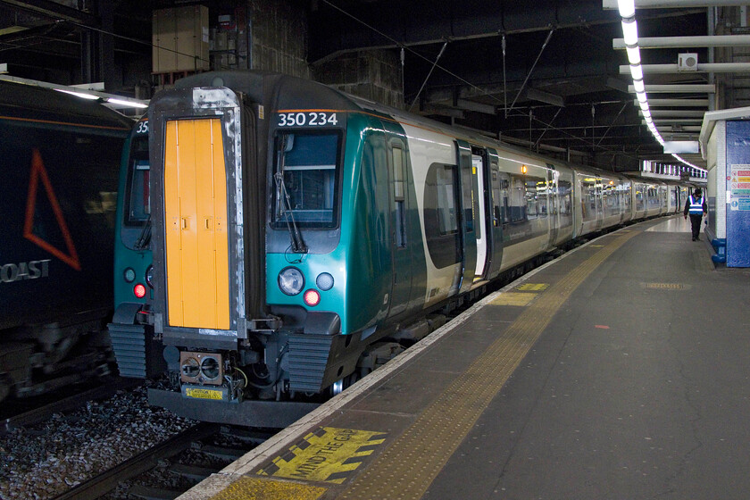 350234, LN 11.56 London Euston-BNS (1Y33, RT), London Euston station 
 As a Pendolino departs from Euston our train home from London to Northampton waits at platform six. My wife and I travelled aboard 350234 as the 11.56 Euston to Birmingham New Street. 
 Keywords: 350234 11.56 London Euston-BNS 1Y33 London Euston station London Northwestern Desiro