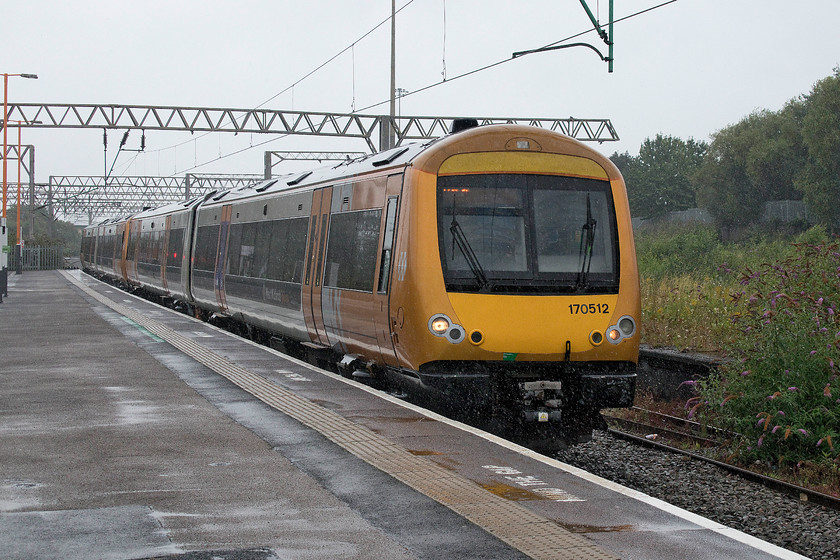 170512 & 170508, LN 10.27 Birmingham New Street-Walsall (2A12, 6L), Duddeston station 
 Taken in tricky conditions holding the camera in one hand and my umbrella in the other 170512 and 170508 arrive at Duddesdon station working the 10.27 Birmingham New Street to Walsall service. Despite its rather austere and bare look, Duddeston station was once a significant one. Originally named Vauxhall, a name it carried until 1974, the station was opened in 1837 as the temporary Birmingham terminus of the Grand Junction Railway from Warrington. When the permanent terminus at Curzon Street opened in 1839, that is to become the terminus for HS2, Vauxhall became a goods-only station until it was rebuilt and re-opened in 1869 by the LNWR. It was renamed Vauxhall and Duddeston in 1889. During an air raid in 1941, it received a direct hit and was destroyed being re-built to then burn down in 1955. The present station dates from this time but little remains apart from the entrance hall, ticket office and steps down to the platforms. 
 Keywords: 170512 & 170508, LN 10.27 Birmingham New Street-Walsall (2A12, 6L), Duddeston station