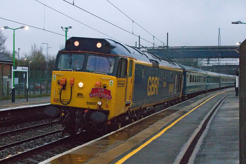 50007, outward leg of The Manchester Christmas Markets, 07.48 London Euston-Preston (1Z50, 1E), Wolverton station 
 In absolutely abysmal weather and the half-light of a December morning 50007 'Hercules' (masquerading as 50014 'Warspite' on the other side) makes a heck of a racket as it picks up speed through Wolverton station after its stop at Milton Keynes. It is working the outward leg of the Manchester Christmas Markets charter that actually ended up at Preston. Leaving Euston at 07.48 the train ran into a little trouble later in its journey with 50007 losing power. I really was asking a lot of the camera's abilities taking this photograph but with a little digital jiggery-pokery, a presentable image has been produced! 
 Keywords: 50007 The Manchester Christmas Markets 07.48 London Euston-Preston 1Z50 
 Wolverton station Herculies GBRf