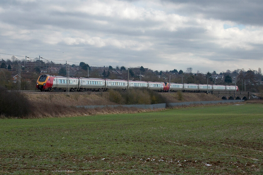 221118 & 221110, VT 10.54 London Euston-Glasgow Central (1S58, 1L), Wilson's Crossing 
 Due to repairs to a semi-collapse of an embankment at Hillmorton Junction near Rugby, for nearly a month, all down services have been routed through Northampton. If the timetable was running at normal levels this would create huge issues on this section of the southern West Coast Mainline so I suppose COVID is actually a bit of a blessing! 221118 and 221110 'James Cook' accelerate away from Northampton at Wilson's Crossing working the 10.54 Euston to Glasgow Central. This service is normally a Pendolino but availability has obviously been an issue that seems a little unusual given the seventy-five per cent timetable. 
 Keywords: 221118 221110 10.54 London Euston-Glasgow Central 1S58 Wilson's Crossing Virgin Voyager Avanti West Coast 	James Cook