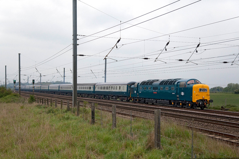 D9009, return leg of The Leeds & Hull-Executive, 17.55 London Kings Cross-Willington (Via Leeds) (1Z12), Langford TL191396 
 As usual on quadruple track, a special is usually pathed on the slow lines so as to keep it out the way of faster traffic. However, with a Deltic, they are pretty capable of keeping up a consistent and fast pace but the signallers in control would probably be too young to remember this! D9009 'Alycidon' is stuck behind a Great Northern stopper service as it approaches Langford in Bedfordshire. It was leading the return Leeds and Hull Executive from King's Cross that, ultimately, would end up at Willington in Derbyshire. The Deltic in rail blue with a matching set of period stock looks and is absolutely right for this line, it's just a shame it was on the slow! 
 Keywords: D9009, return leg of "The Leeds & Hull-Executive", 17.55 London Kings Cross-Willington (Via Leeds) (1Z12), Langford TL191396