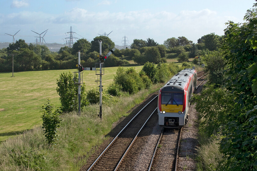 175003, AW 07.34 Manchester Airport-Llandudno (1D34, 4L), Lower Rake Lane Helsby 
 Taken from an occupation bridge that carries Lower Rake Lane to a farm at Helsby 175003 is seen approaching working the 07.34 Manchester Airport to Llandudno Transport for Wales service. Beyond the Frodsham Wind Farm Runcorn can just be seen slightly elevated from the nearby land on the Mersey Estuary. Notice the pair of semaphores to the left of the train. The lower submissive arm controls access to the now freight-only route to Ellsmere Port. 
 Keywords: 175003 07.34 Manchester Airport-Llandudno 1D34 Lower Rake Lane Helsby