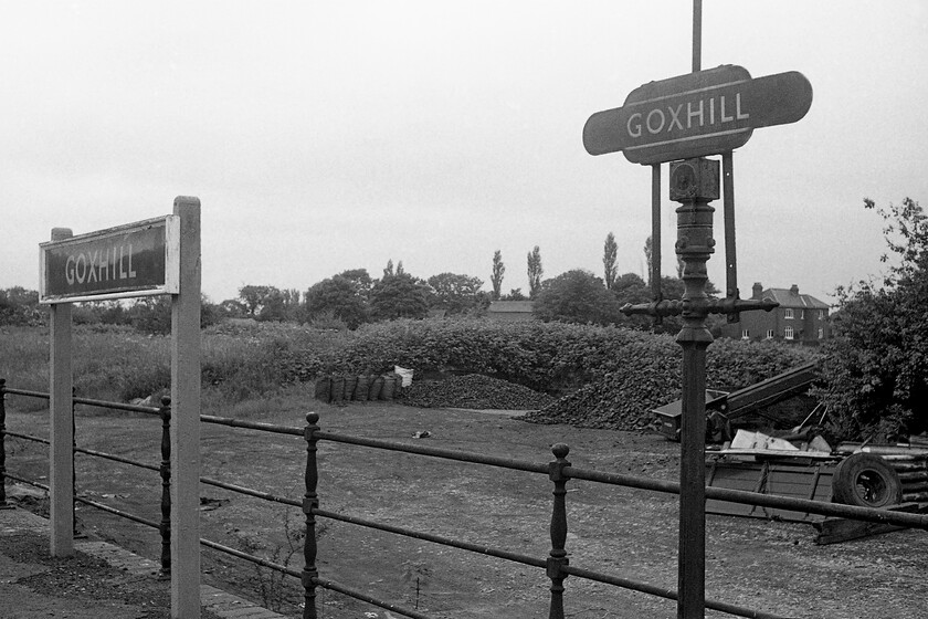 Enamel & totem, Goxhill station 
 A walk along Goxhill station's platforms even as late as 1981 was like going back in time to another railway era! With its coal yard still appearing to be in use the platforms proudly have a large blue enamel (possibly of LNER vintage due to its non-flanged and wooden framed edges) and a totem. The post to which the totem is attached has the remains of its gas lighting control valve. One cannot help to wonder where this totem ended up. I hope that it was not simply thrown away when the station was 'upgraded' and that it still exists today. If so, the lucky owner may well be in receipt of a piece of railway memorabilia worth several thousand pounds! 
 Keywords: Enamel totem Goxhill station totem BR blue enamel