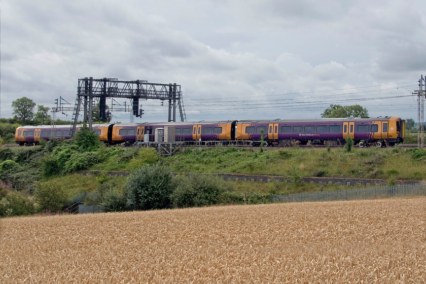 Class 172, 09.16 Ilford EMUD-Tyseley (5Q66, 4E), between Roade & Ashton 
 An unidentified West Midlands Trains Class 172 makes its way down the WCML back home to its base at Tyseley. The unit left Ilford depot running as 5Q66 after having wheel turning on the only lathe capable of undertaking this work; what utter madness is that! I chose this spot as there was full cloud but just as the train approached the sun managed to find some thinness in the cloud thus creating tricky backlighting that needed considerable Photoshop treatment - how ironic! 
 Keywords: Class 172 09.16 Ilford EMUD-Tyseley 5Q66 between Roade & Ashton West Midlands Trains