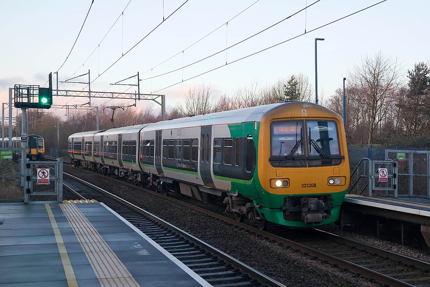 323208, LN 15.01 Wolverhampton-Walsall (2A39, 2E), Tipton station 
 323201 arrives at Tipton station in the dying rays of winter sunshine forming the 15.01 Wolverhampton to Walsall working (2A39). The class 323s have been a familiar site on the Birmingham commuter lines for over twenty years now. However, at the time of writing in 2018, their future is uncertain beyond 2020. They are very reliable, fast accelerating and comfortable units. Also, since refurbishment was relatively recent, they are in good condition. 
 Keywords: 323208 2A39 Tipton station