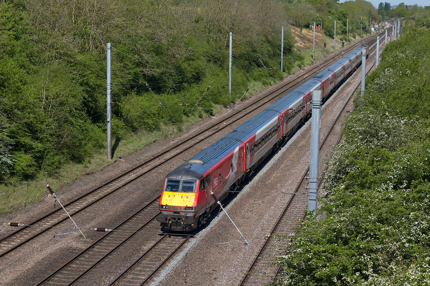 82201 & 91112, 09.45 Leeds-London King`s Cross (1A20, RT), High bridge, Westby SK962271 
 Having surmounted Stoke summit and passed through the tunnel, DVT 82201 is leading the 09.45 Leeds to London King's Cross with 91112 pushing at the rear. The train is about to pass under High bridge near the village of Westby between Grantham and Peterborough. It is interesting to compare this scene with a photograph taken at the same location in August 1978 that illustrates the result of unmanaged embankments and is the reason why the team of NR staff is seen in the distance starting on what will prove to be a pretty mammoth task of tree clearance! See.... https://www.ontheupfast.com/v/photos/21936chg/25410357404/x55009-14-13-york-london-king-s-cross 
 Keywords: 82201 91112 09.45 Leeds-London King`s Cross 1A20 High bridge, Westby SK962271