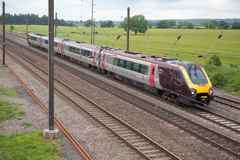 220028, XC 13.35 Newcastle-Guildford (1O40), Otterington SE380879 
 220028 is probably going at full line speed here on the ECML past Otterington between Thirsk and Northallerton. The CrossCountry Voyager is working the 13.35 Newcastle to Guildford. 
 Keywords: 220028 13.35 Newcastle-Guildford 1O40 Otterington SE380879