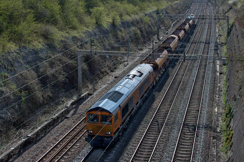 66792 & 66759, 08.30 Willesden No. 7-Bescot (6G54, 2E), Roade cutting 
 The 08.30 Willesden to Bescot engineering train passes through Road cutting lad by GBRf's 66792 with 66759 'Chippy' at the rear. The train is composed of five wagons four of which are JJA autoballasters. The leading locomotive was delivered to UK shores (arriving at Hull in July 2019) following use on Swedish railway numbered T66404. Along with the trailing locomotive, both of these GBRf Class 66s were photographic cops making my Sunday walk worthwhile even if I was labouring with a very painful knee; oh. the joys of getting older! 
 Keywords: 66792 66759, 08.30 Willesden No. 7-Bescot 6G54 Roade cutting