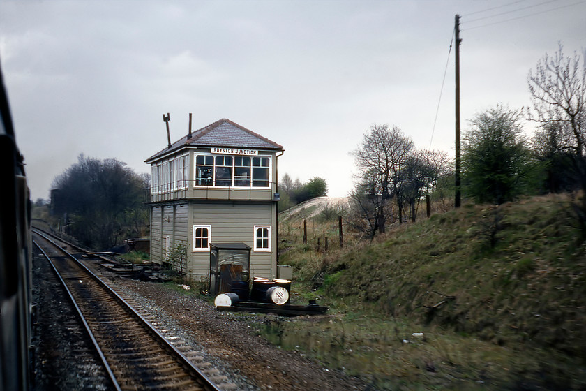 Royston Junction signal box (Mid, date 1901) 
 Having passed Royston Junction signal box I have turned my camera south to capture the Midland Type 3b structure. The box controlled the junction with the Midland route to Crigglestone and beyond. The abutment of the bridge that carried the Great Central line over the Midland can just be seen to the left of the trees towards the back of the train. Notice the jaunty angle of the stovepipe emerging from the roof of the box. Photographs of the box taken soon after this one show this removed. It looks like this work was somewhat overdue! 
 Keywords: Royston Junction Signal Box