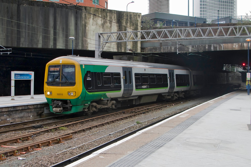 323213, LM 15.12 Redditch-LichfieldTrent Valley (2P59), Birmingham New Street station 
 The brutalist concrete structure of the 1960s designed and built Birmingham New Street station is seen here clearly weathering and not looking at its best! 323213 enters the station working the cross-city 15.12 Redditch to Lichfield Trent Valley. Notice the very top floor of New Street's 1966 built power signal box above the level of the roadway, the structure is now grade II listed. 
 Keywords: 323213 15.12 Redditch-Lichfield Trent Valley 2P59 Birmingham New Street station