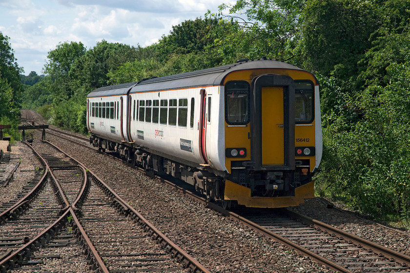 156412, 11.26 Sudbury-Marks Tey (2T13, RT), Chappel & Wakes Colne station 
 Looking south from Chappel and Wakes Colne station sees 156412 leaving with the 11.26 Sudbury to Marks Tey. Even though it can't be seen, in the far distance where the track straightens out it is crossing the impressive 1 000 foot long Chappel Viaduct that crosses the Colne Valley. 
 Keywords: 156412 2T13 Chappel & Wakes Colne station