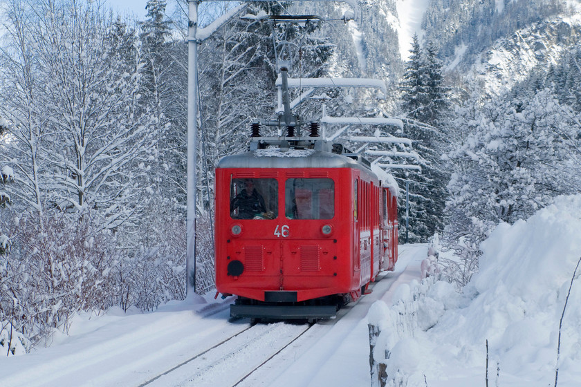 46 & 62, ECS following snow-clearance, Chamonix-Montenvers Mer De Glace line, Chemin du Pied-du Grepon foot crossing 
 Descending extremely gingerly, at less than walking pace, passenger cars 46 and 62 are brought down to the base station of the Montenvers mountain railway. Following snow clearance by two diesels, that had just passed me, it would be hoped that passenger services would commence soon. With so much snow, ski conditions were surprisingly difficult so a lot of visitors to Chamonix would probably be looking for something different to do. A trip up the Montenvers railway to the Mer de Gace would be a great way to spend the day so I suspect that the railway was anxious to get operations underway as soon as possible! 
 Keywords: 46 62 ECS following snow-clearance Chamonix-Montenvers Mer De Glace line, Chemin du Pied-du Grepon foot crossing