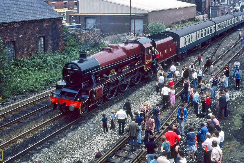 5690, BR sponsored Manchester-Liverpool Edge Hill Special, photo stop, Earlestown station 
 With a queue of parents and excited children waiting to climb aboard the cab of 5690 'Leander' at Earlstown station, plenty of others clamber around the tracks. In this image there were no officials in sight with the public simply wandering about; a sight unheard of today even on preservation lines. The LMS Jubilee was leading the outward leg of train running from Manchester to Liverpool Edge Hill as part of the summer's Rocket 150 celebrations. 
 Keywords: 5690 BR sponsored Manchester-Liverpool Edge Hill Special, photo stop Earlestown station Leander LMS