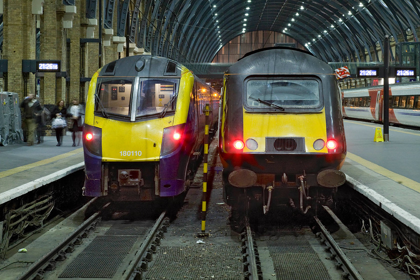 180110, HT 18.36 Hull-London King's Cross (1A96) & 43423, GC 17.29 Sunderland-London King's Cross (1A69), London King's Cross station 
 Two open access operators' trains stand on the blocks at London King's Cross. To the left Hull Trains' 180110 has just arrived having worked the 1A96 18.36 from Hull with its passengers still making their way down the platform. To the right Grand Central's HST power car has led their 1A69 17.29 from Sunderland. In its original guise numbered 43123 this particular power car was entered service on the ECML in May 1979 as a 'spare' power car (along with 43122) both were never assigned to a particular numbered set like all of the others. It has spent its entire thirty-six years of service thrashing up and down the ECML ever since. 
 Keywords: 180110 18.36 Hull-London King's Cross 1A96 43423 17.29 Sunderland-London King's Cross 1A69 London King's Cross station Open operator Hull Trains Grand Central