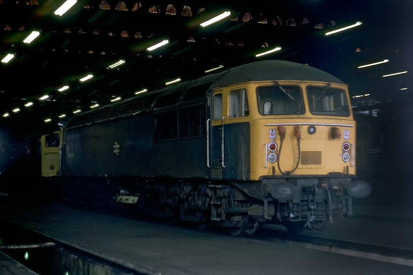 2. 56050, stabled, Toton MPD 
 In 1979, I was using Kodachrome 64 film in my Zenith EM camera. With the slow speed of this film, taking pictures in low light was a constant challenge so pictures inside the depot were virtually impossible without a tripod or flash; I had neither. This was unfortunate as I encountered lines of locomotives that were all worthy of a picture. So, I had to content myself with this picture of 56050 and 25101 sitting just inside one of the roads. This 56 had been in traffic exactly a year when this photograph was taken. 
 Keywords: 56050 stabled Toton MPD