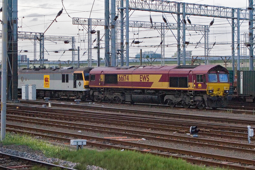 92037 & 66174, stabled, Wembley Yard 
 The technically advanced bi-mode Class 92s must be the most under-utilised locomotives on the network. Many have gone to Europe with those remaining in the UK either in warm storage or seeing very limited use. 92037 'Sullivan' sits idle in Wembley Yard along with 66174. Both wear the branding (and paint scheme in the case of the Class 66) of their previous operator EWS. 
 Keywords: 92037 & 66174, stabled, Wembley Yard Sullivan