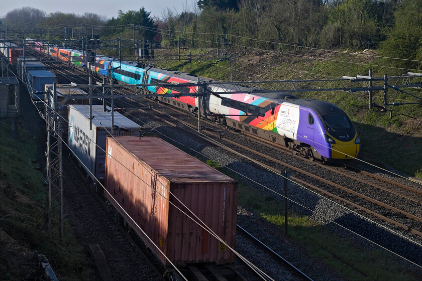 390119, VT 07.13 London Euston-Manchester Piccadilly (1H04, 4L) & 05.00 Crewe BH-Felixstowe North (4L89, RT), Victoria bridge 
 As the 4L89 05.00 Crewe Basford Hall to Felixstowe Freightliner heads south celebrity Pendolino 390119 heads north working the 07.13 Euston to Manchester Piccadilly. I have precious few photographs of the PRIDE-wrapped Class 390 that appeared on the tracks back in 2020. AWC has stated that this is not a transient livery application but is going to be a permanent fixture of their fleet 
 Keywords: 390119 07.13 London Euston-Manchester Piccadilly 1H04 05.00 Crewe BH-Felixstowe North 4L89 Victoria bridge AWC Avanti West Coast Pendolino