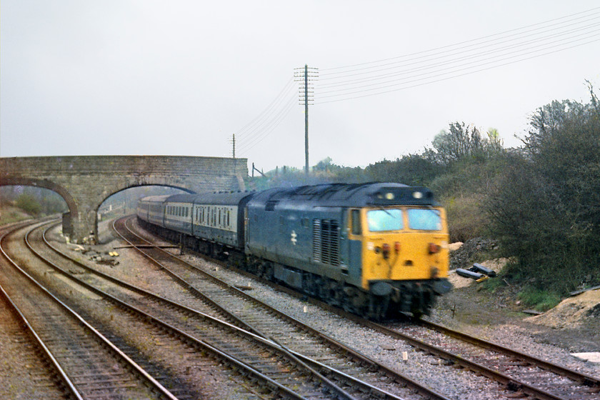 50050, unidentified down working, from Fairwood Junction signal box 
 Taken from the end window of Fairwood Junction signal box, 50050 rushes past with an unidentified down working from Paddington. Unfortunately, the scourge of motion blur has spoilt this image. The two tracks to the left are the ones leading to and from Westbury station whilst the 50 is on the cut-off avoider line that was opened by the GWR in 1933 in an effort to speed up timings to the West Country 
 Keywords: 50013 down working from Fairwood Junction signal box