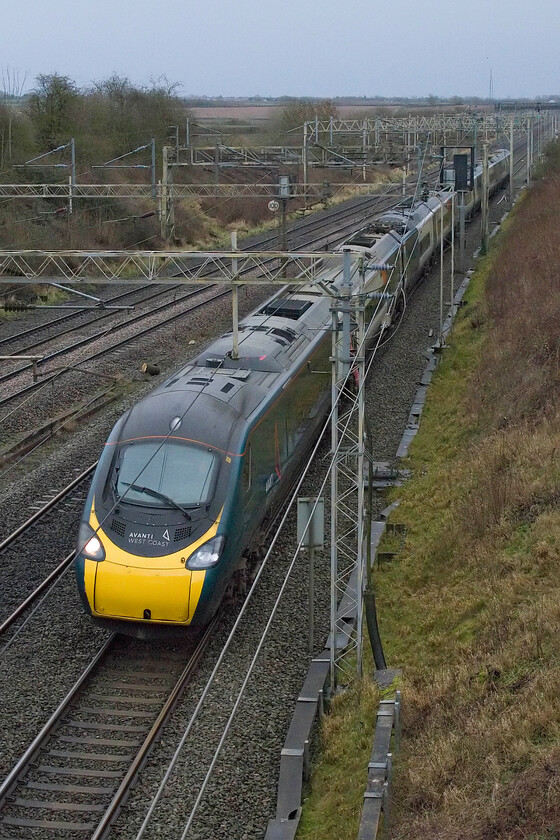 390006, VT 13.29 London Euston-Glasgow Central (1S69, RT), Victoria bridge 
 Unfortunately, 390006 'Charles Rennie Mackintosh' has lost its distinctive front mounted moustache that marked it out from the rest of the Pendolino fleet. It is seen passing Victoria bridge just south of Roade working the 1S69 13.29 Euston to Carlisle service. 
 Keywords: 390006 13.29 London Euston-Glasgow Central 1S69 Victoria bridge AWC Avanti West Coast Pendolino Charles Rennie Mackintosh