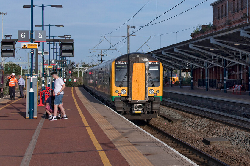 350258 & 350236, LN 17.33 Crewe-London Euston (1U40, 4L), Rugby station 
 Mike and travelled aboard 350258 and 250236 working the 17.33 Crewe to Euston service from Crew to Rugby where it is seen leaving in some glorious evening sunshine. With it being such a warm day we were grateful tha the air conditioning on the front carriage of 350258 appeared to working well but it does not always do so on these units if one walks through a unit from carriage to carriage noticing the very hit and miss nature of its reliability throughout! 
 Keywords: 350258 350236 17.33 Crewe-London Euston 1U40 Rugby station London Northwestern Desiro