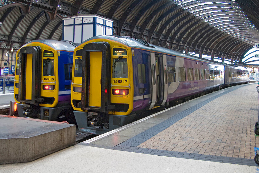 158855, NT 08.43 York-Hull (2R91) & 158817, NT 09.18 York-Blackpool North (1B16), York station 
 Two Northern services stand at York station ready to leave within next half an hour or so. To the left, 158855 will work the 08.43 to Hull whilst to the right 158817 the 09.18 to Blackpool North. 
 Keywords: 158855 08.43 York-Hull 2R91 158817 09.18 York-Blackpool North 1B16 York station Northern