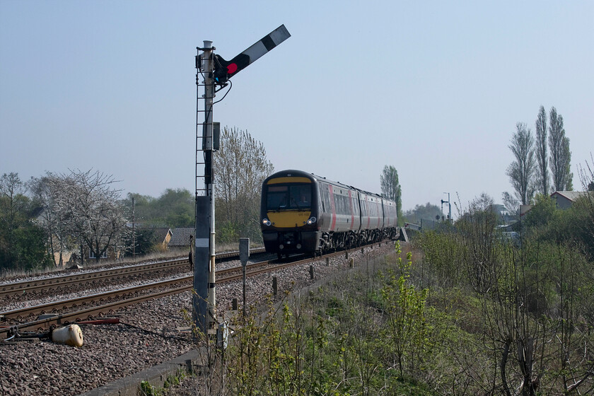 170102, XC 10.00 Cambridge-Birmingham New Street (1N49, RT), Harts Drove crossing TL273962 
 Whittlesey station (or Whittlesea as the station is named) is just in the distance of this photograph where the starter signal can just be seen. It's a split platform with a large mechanical signal box located at the far eastern end at the level crossing where there is also a modern but rather small crossing box. The 10.00 Cambridge to Birmingham New Street service, worked by 170102, has not stopped at the station and is seen passing the home signal at the village's Harts Drove crossing, a user worked example where the drivers of vehicles have to contact the signalman for permission to cross. 
 Keywords: 170102 10.00 Cambridge-Birmingham New Street 1N49 Harts Drove crossing TL273962 XC CrossCountry