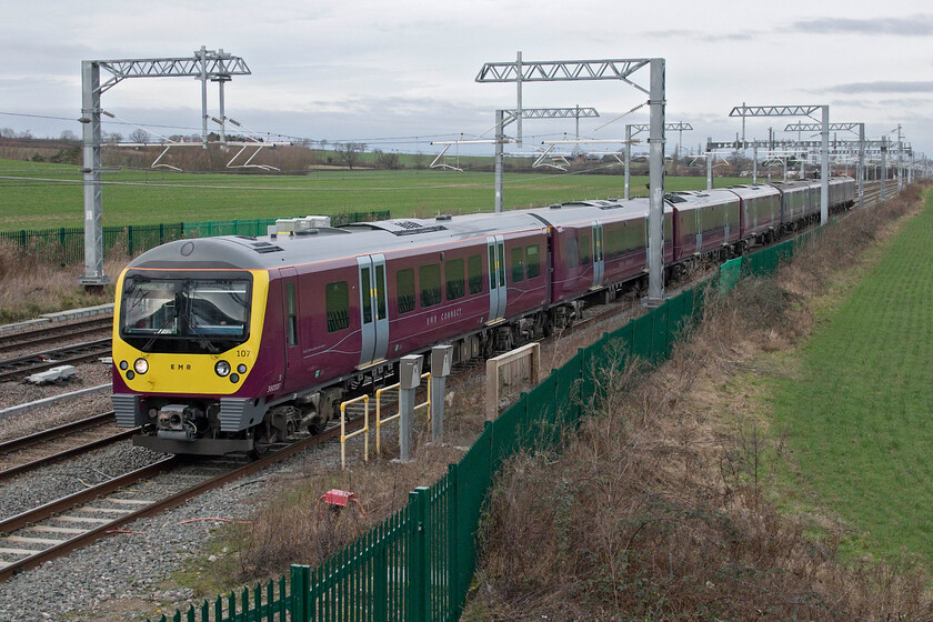 360107 & 360110, EM 13.40 Corby-London St. Pancras (1Y34, 1L), Harrowden Junction 
 Andy and I drove from Peterborough back to Wellingborough deciding to visit Harrowden Junction. It was my first time at this classic location since the completion of the electrification but still finding it a reasonably good photographic spot despite the masts, wires and palisade fencing. 360107 and 360110 head south on the up slow working the 13.40 Corby to St. Pancras service. With the leading unit being in receipt of a full repaint into EMR's house colours the front of the Desiro takes on a very different look that is no bad thing as, personally, I do find the front end of these trains a little odd looking! 
 Keywords: 360107 360110 13.40 Corby-London St. Pancras 1Y34 Harrowden Junction East Midlands Railways Desiro