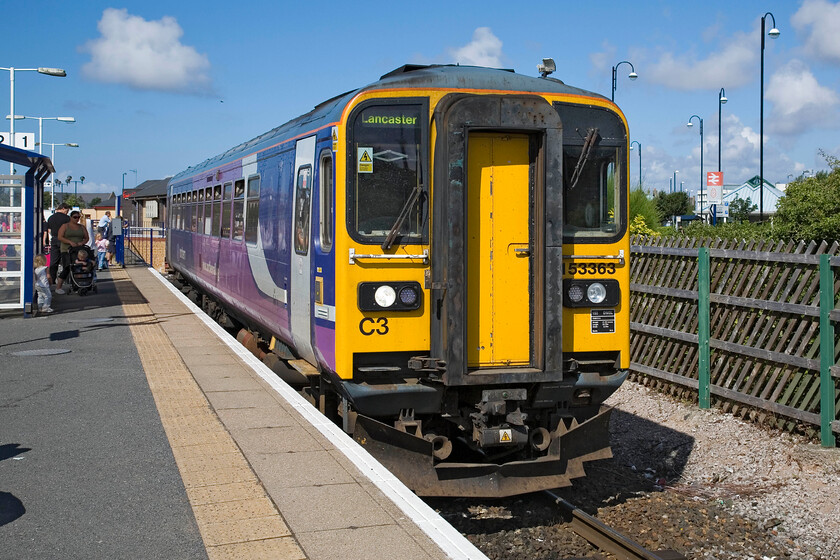 153363, NT 10.34 Morecambe-Lancaster, Morecambe station 
 The 10.34 Morecambe to Lancaster service worked by 153363 waits to depart from Morecambe station on a sunny summer's morning. Since my last visit way back in 1985 the station has moved from its original location some distance beyond the rear of the train to this single platform affair with very limited facilities. Gone are the days of large numbers of summer specials arriving at this popular resort town with the stock being stabled in the vast area of carriage sidings that once occupied this spot and the adjacent Morrisons supermarket. 
 Keywords: 153363 10.34 Morecambe-Lancaster Morecambe station Northern Traina