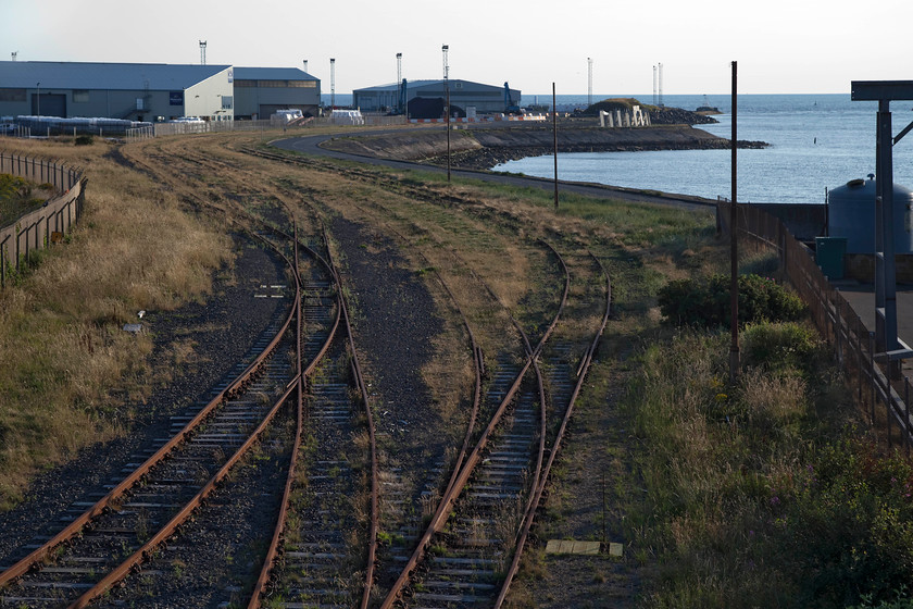 Sidings to Ayr Harbour, Limekilns Road bridge 
 Viewed from Limekilns Road bridge Ayr Harbour can be seen. The tracks leading to the harbour complex are heavily rusted now through a lack of use. Until the downturn in coal being used to generate electricity, there were regular flows to and from the harbour. One wonders if any new flows will emerge or if that's it for the harbour and its rail links? 
 Keywords: Sidings to Ayr Harbour, Limekilns Road bridge