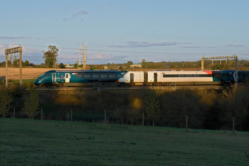 805012, 16.35 London Euston-Crewe (3K97, 3L), Roade Hill 
 AWC's Evero 805012 undergoes yet another test/mileage accumulation/staff training run* between Roade and Ashton running as 3K97, the 16.35 Euston to Crewe. It is noticeable now that the number of Voyagers passing is significantly less as more of the 805s enter service. If the work to get them all running has been chronological then it means that this is the penultimate one with just 805013 to be seen. But, then there are the much delayed Class 807s of course!

* delete as appropriate! 
 Keywords: 805012 16.35 London Euston-Crewe 3K97 Roade Hill AWC Avanti West Coast Evero