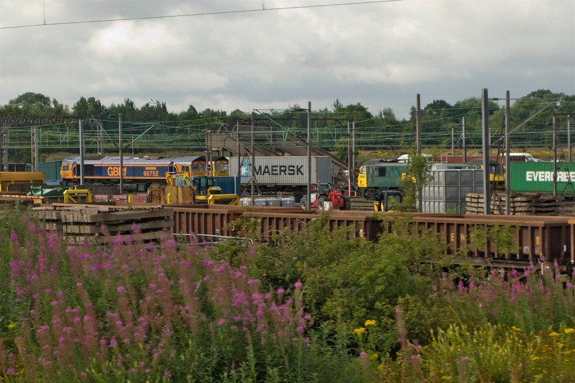 66752, Class 66 & Class 91, Crewe Basford Hall yard 
 The usual busy scene in Freightliner's Basford Hall yard is seen as we approach Crewe. The only identifiable locomotive from the trio on view is 66752 'The Hoosier State'. The Class 66 lurking behind the GBRf locomotive and the Class 91 remain a mystery. 
 Keywords: 66752 class 66 Class 91 Crewe Basford Hall yard Shed Skoda The Hoosier State