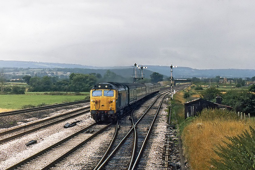 50029, 05.57 Plymouth-London Paddington, Cogload Junction signal box 
 Taken from Cogload Junction Signal Box, 50029 'Renown' races past with the 05.47 Plymouth to London Paddington. I enjoyed a good strong cup of tea with the signalman and the promise of a longer visit on my return journey. This view clearly shows the quadruple track layout between Cogload and Taunton that existed until re-signaling and track rationalisation in 1986 that saw four tracks reduced to two. 
 Keywords: 50029 05.57 Plymouth-London Paddington Cogload Junction signal box