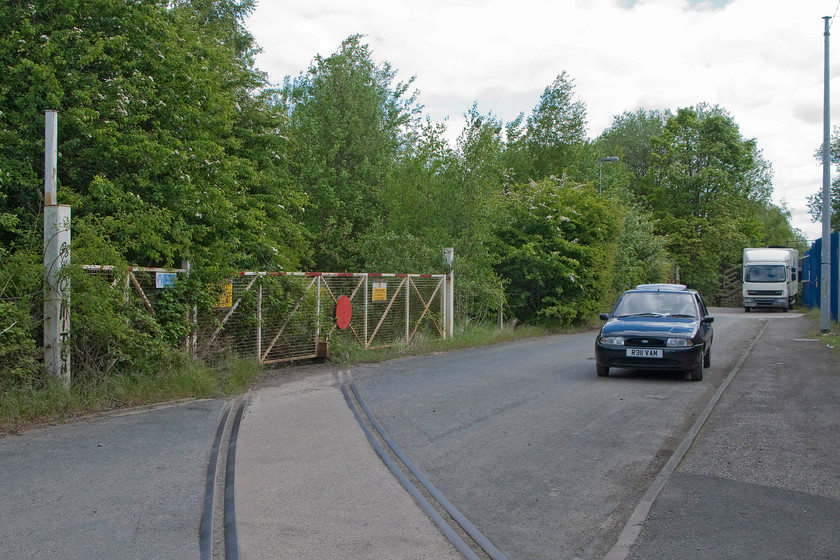 Former level crossing gates & track, Forge Lane, Horbury Junction 
 Our delightfull drive home from Wakefield in the shape of a 1997 Ford Fiesta is seen in full view here on Forge Lane at Horbury Junction! The redundant, but still mainline connected, track leads into the former Horbury railway works (Charles Roberts and Co Ltd railway wagon works) that ceased its railway operations in 2005 now being the home to a number of industrial units. Whilst none of these new occupiers of the site are involved any railway activity (that I'm aware of) the huge network of the track is still in place. A study of the site from Google Earth reveals this network and to the far southern end of the site what appears to be the remains of the traversers used to move larger coaches and vehicles from different parts of the site. 
 Keywords: Former level crossing gates track Forge Lane Horbury Junction