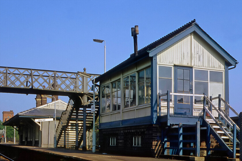 Flint signal box (LMS, 1932) 
 With its stove pope at a jaunty angle, Flint signal box stands proudly on the station's up platform. Unlike nearly all of the signal boxes on the North Wales route, this example was to an LMS design being constructed later in 1932. Notice the cast No Admittance sign attached adjacent to the door of the box. Unfortunatelty, the box was demolished in 1990 some twenty-eight years before the rest of the boxes along the route were closed. 
 Keywords: Flint signal box LMS, 1932