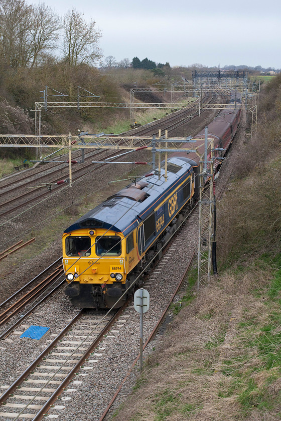 66744, 06.16 Burton-ot-Wetmore sidings-London Euston ECS (5Z45), Victoria bridge 
 66744 'Crossrail' leads a random set of Mk. II stock, mainly composed of ex. Virgin coaches, past Victoria bridge south of Roade. This was the 5Z45 06.16 Burton-ot-Wetmore to London Euston ECS move . This stock was used later in the day to carry Spurs supporters to Liverpool for their Premiere League clash. 
 Keywords: 66744 06.16 Burton-ot-Wetmore sidings-London Euston ECS 5Z45 Victoria bridge