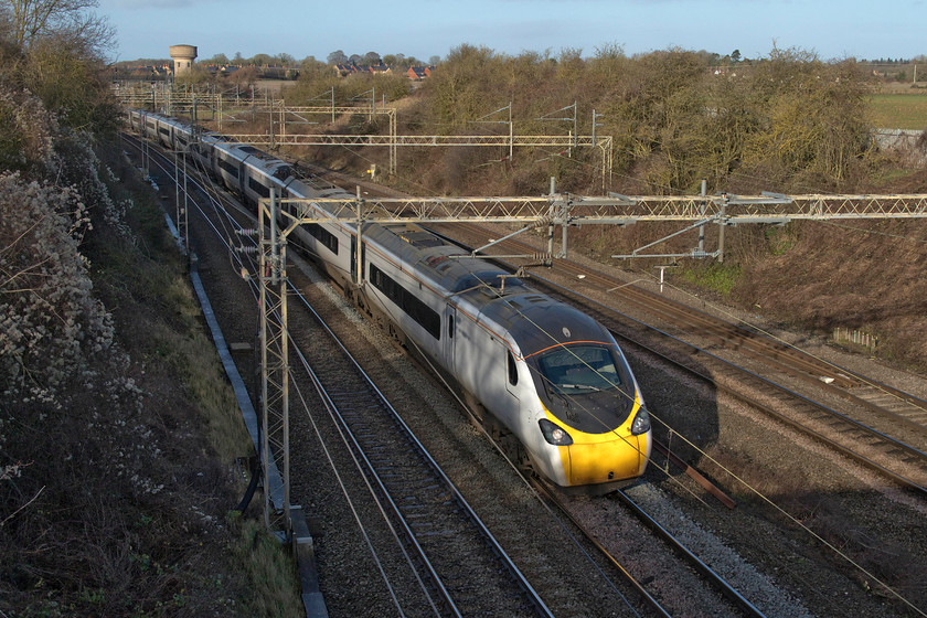 390127, VT 07.37 Glasgow Central-London Euston (1M08, 13L), Victoria bridge 
 In lovely winter sunshine, 390127 sweeps around the curve just south of Roade working the 07.27 Glasgow Central to Euston service. This Pendolino is still in its 'nude' livery having yet to receive the Avanti West Coast treatment, something that will happen in the coming weeks. 
 Keywords: 390127 07.37 Glasgow Central-London Euston 1M08 Victoria bridge Avanti West Coast Pendolino Roade water tower