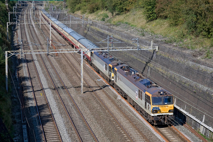 92028 & 92038, 11.53 Crewe-Basingstoke GB Railfreight Excursion (1Z50), Roade cutting 
 Something that is not seen that often this far south now but that was more common a few years ago is a Class 92 and even rarer a working pair hauling a non-freight train! 92028 Saint-Sans leads 92038 Voltaire through Roade cutting heading the comically titled AC/DC Highway to Hampshire private charter operated by and for GBRf employees and other invited guests. Unlike many charters with ridiculously early start times, this was far more leisurely leaving Crewe at 11.53 and completing a there-and-back trip to Basingstoke with a brace of the companys Class 73 taking over from Wembley Yard. Notice that the Class 92s are wearing their Europorte branding as this French company acquired GBRf for an eyewatering 31 back in 2010. 
 Keywords: 92028 92038 11.53 Crewe-Basingstoke GB Railfreight Excursion 1Z50 Roade cutting Europorte Saint-Sans Voltaire