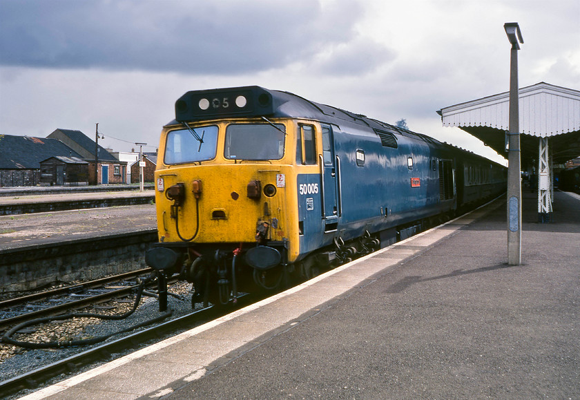 50005, 08.30 London Paddington-Paignton (1B36), Taunton station 
 Despite the threatening looking clouds, the sun is actually just out, brightening up the scene here at Taunton station. 50005 'Collingwood' has just arrived with the 1B36 08.30 from Paddington to Paignton. When this photograph was taken, 50005 was twelve years old and beginning to look a little battle-weary but it still had another two years to go before entering Doncaster for its much-needed refurbishment. It was always recognisable at this time as it had the unofficial 05 painted on its blanked off headcode panel.

There is an audio recording of this event on my youtube channel, see..https://youtu.be/8GwJXSDd4zE 
 Keywords: 50005 08.30 London Paddington-Paignton 1B36 Taunton station Collingwood