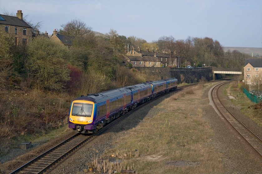 170308 & 170304, TP 16.55 Manchester Airport-Cleethorpes (1B86), Chinley station 
 Having taken a picture in the opposite direction at Chinley station from the footbridge, I decided on a going-away shot due to the far more satisfactory lighting looking east on this early spring late afternoon. 170308 and 170304 are seen working the 16.55 Manchester Airport to Cleethorpes service, next stop will be Sheffield. In this view, the clear space is where the former platforms were located and also give away that there was once four through roads here. 
 Keywords: 170304 170308 16.55 Manchester Airport-Cleethorpes 1B86 Chinley station